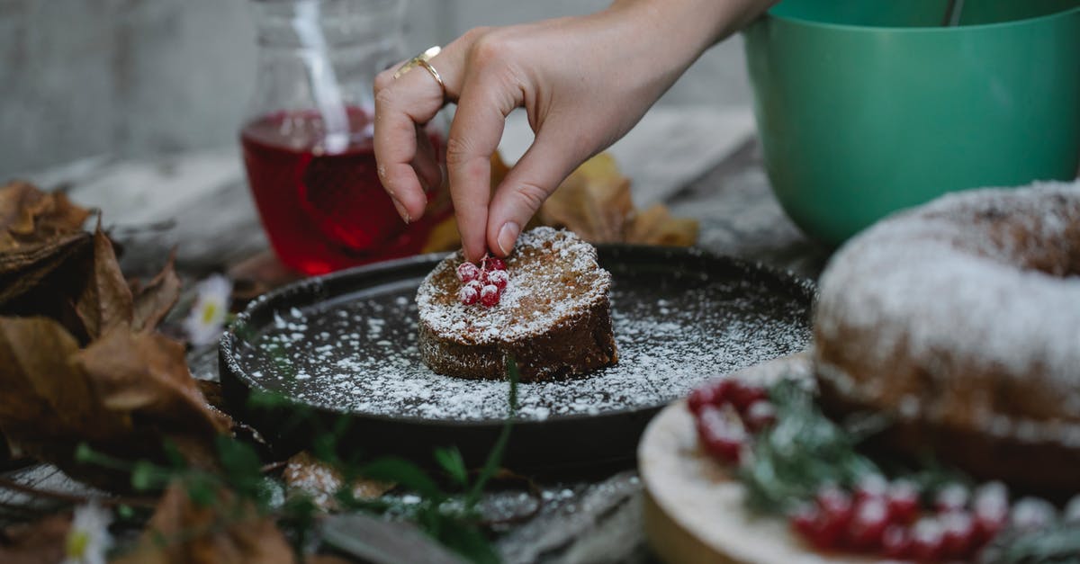 How do I add butter to a sponge cake? - Crop faceless housewife decorating pie slice with red currant How do I add butter to a sponge cake? - Crop faceless housewife decorating pie slice with red currant