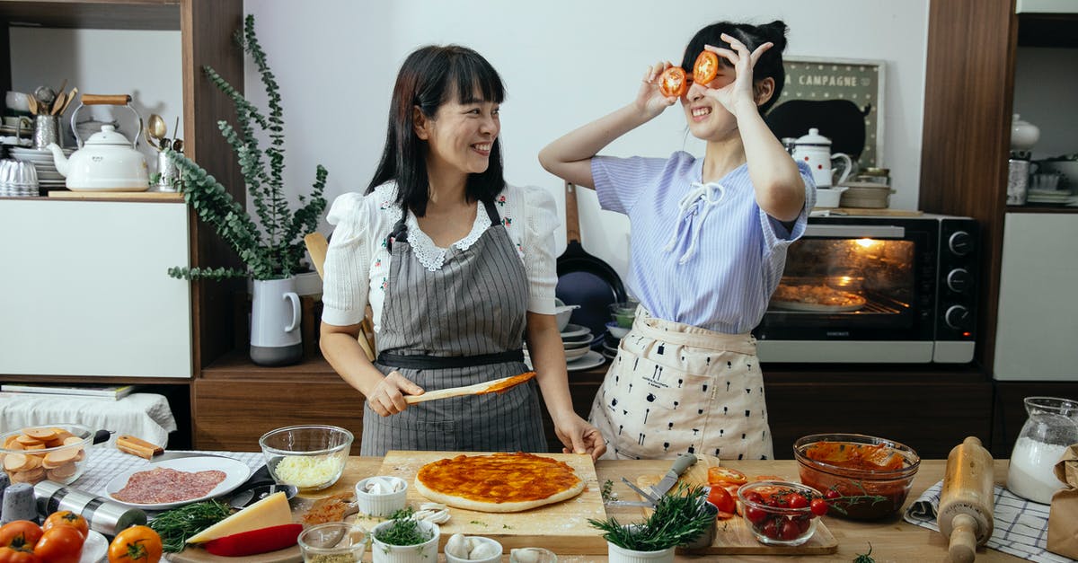How do I add menthol flavoring to this gum? - Smiling Asian woman spreading tomato sauce on pizza dough while looking at funny female covering eyes with tomato slices in kitchen How do I add menthol flavoring to this gum? - Smiling Asian woman spreading tomato sauce on pizza dough while looking at funny female covering eyes with tomato slices in kitchen