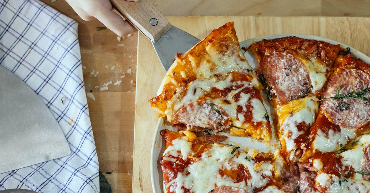 How do I adjust the temp to bake country ribs so they take twice as long? - Top view of unrecognizable cook taking slice of fresh baked pizza with spatula placed on wooden cutting board in kitchen How do I adjust the temp to bake country ribs so they take twice as long? - Top view of unrecognizable cook taking slice of fresh baked pizza with spatula placed on wooden cutting board in kitchen