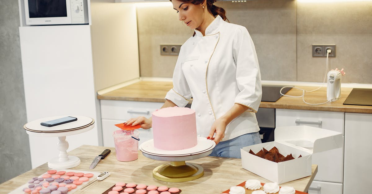How do I change cake recipes for cupcakes? - Serious young woman in apron preparing desserts in modern confectionery How do I change cake recipes for cupcakes? - Serious young woman in apron preparing desserts in modern confectionery