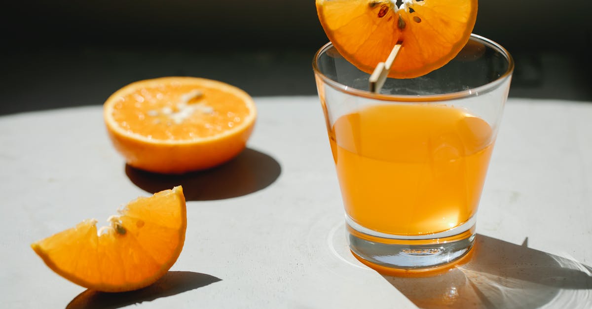 How do I concentrate the flavor in orange juice? - Palatable fresh juicy orange cut in slices with transparent glass of orange juice How do I concentrate the flavor in orange juice? - Palatable fresh juicy orange cut in slices with transparent glass of orange juice