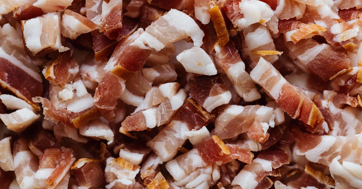 How do I cook large quantities of sliced bacon? - Closeup top view heap of delicious scrumptious pork bellies bacon cut into small slices before cooking process How do I cook large quantities of sliced bacon? - Closeup top view heap of delicious scrumptious pork bellies bacon cut into small slices before cooking process