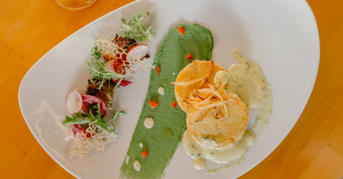 How do I cook scallops? - From above of delicious scallops with veggies served on plated decorated with smeared green sauce How do I cook scallops? - From above of delicious scallops with veggies served on plated decorated with smeared green sauce