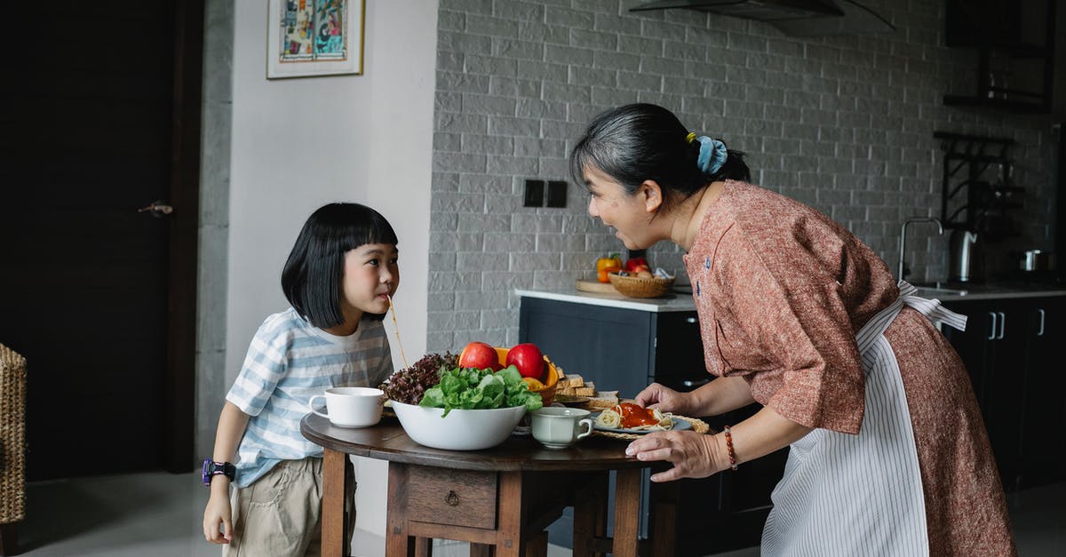 How do I cook toast on an Aga? - Happy woman with little girl preparing healthy lunch How do I cook toast on an Aga? - Happy woman with little girl preparing healthy lunch