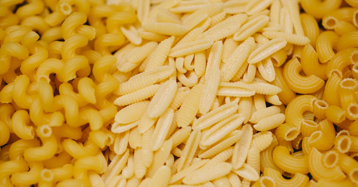 How do I get rid of excess flour on my dried pasta shapes? - Pile of assorted small pasta types scattered on table How do I get rid of excess flour on my dried pasta shapes? - Pile of assorted small pasta types scattered on table