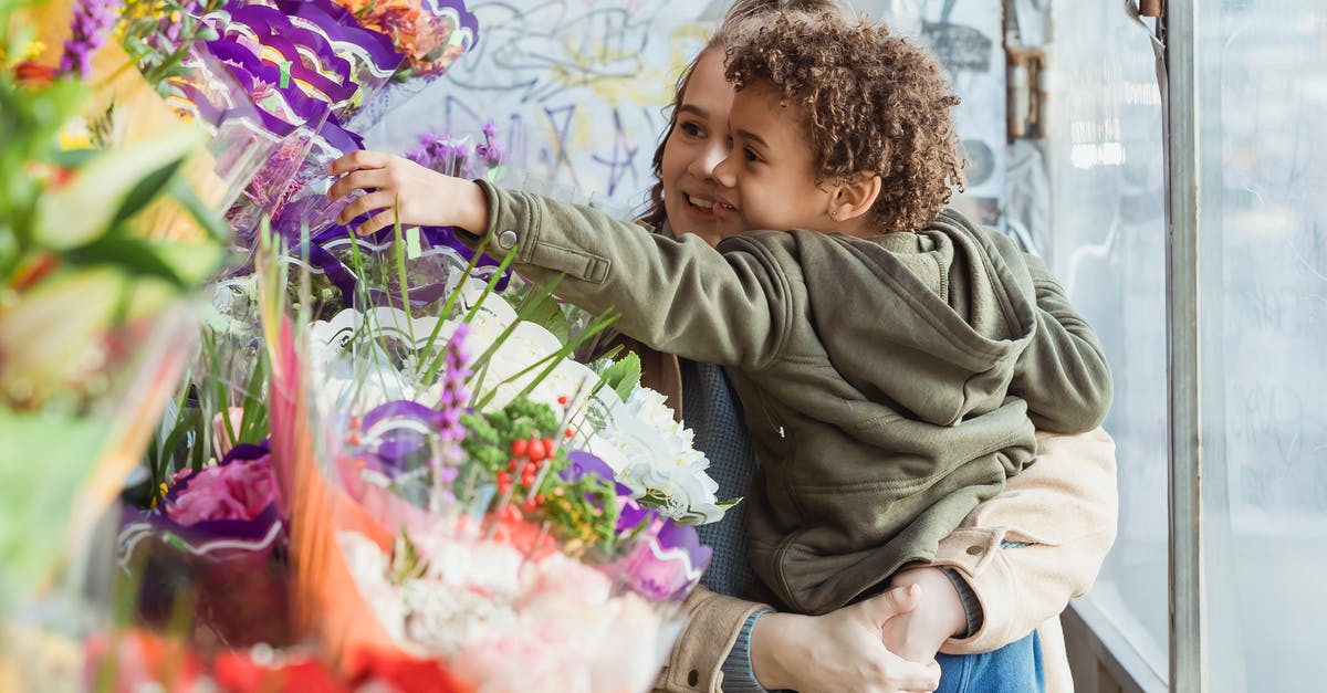 How do I get rid of smells and tastes leaching into other cookies when stored together for gifts? - Smiling mother holding cute black son on hands while choosing together bouquet in floristry store How do I get rid of smells and tastes leaching into other cookies when stored together for gifts? - Smiling mother holding cute black son on hands while choosing together bouquet in floristry store