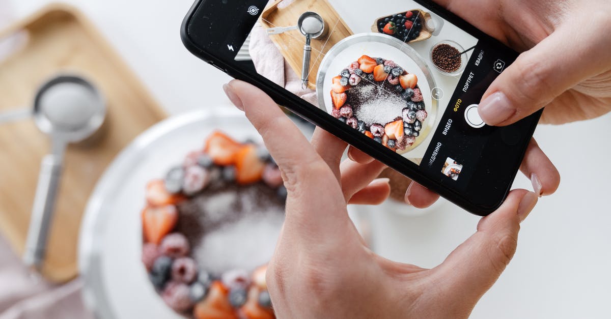 How do I glaze vegetables? - Woman hand taking photo on smartphone of delicious decorated cake How do I glaze vegetables? - Woman hand taking photo on smartphone of delicious decorated cake