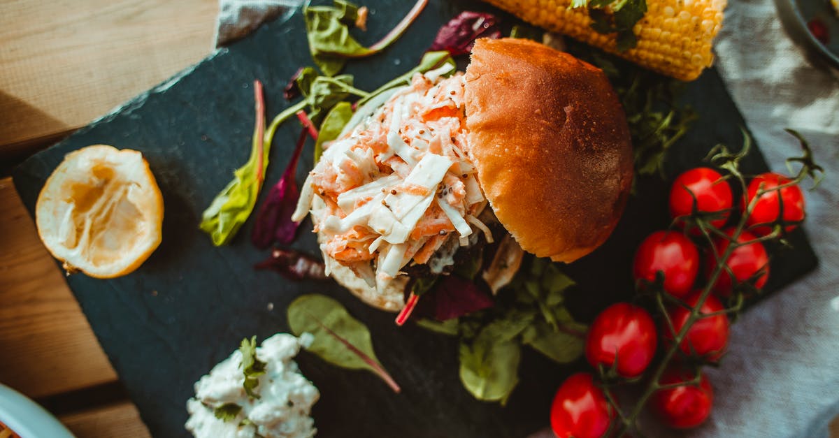 How do I impart the flavor of mint to a tomato sauce? [duplicate] - Top view of tasty appetizing hamburger served with brunch of tomatoes and grilled corn on wooden board on napkin in restaurant
