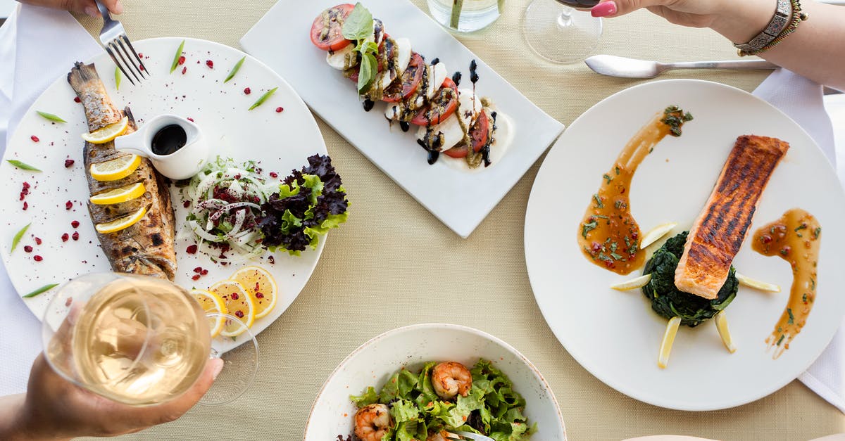 How do I know if my salmon fish is cooked properly? - Person Holding Fork and Knife Slicing Vegetable on White Ceramic Plate How do I know if my salmon fish is cooked properly? - Person Holding Fork and Knife Slicing Vegetable on White Ceramic Plate