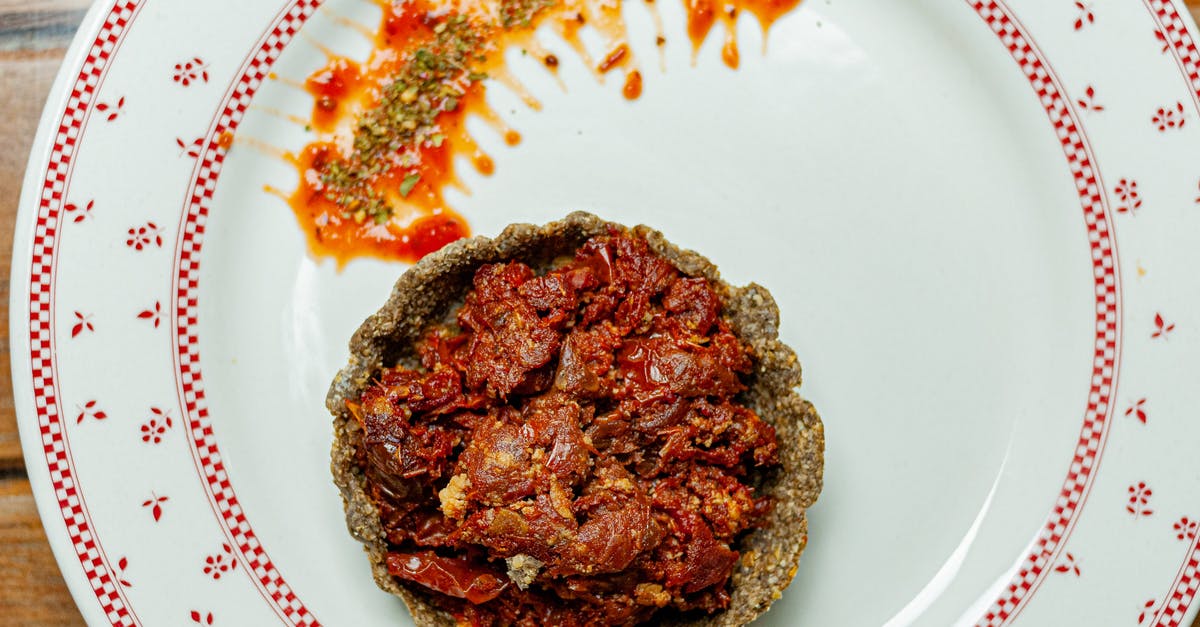 How do I know when quiche is finished cooking? - From above of appetizing vegetarian quiche with tomatoes and sauce on white plate How do I know when quiche is finished cooking? - From above of appetizing vegetarian quiche with tomatoes and sauce on white plate