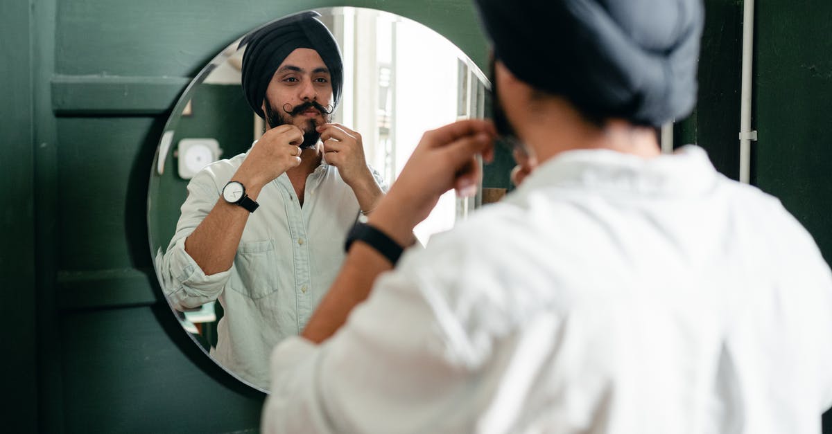 How do I make authentic Russian black bread? - Back view of young Indian male with twisted mustache wearing denim shirt and turban taking care of beard standing against mirror on wall during daytime How do I make authentic Russian black bread? - Back view of young Indian male with twisted mustache wearing denim shirt and turban taking care of beard standing against mirror on wall during daytime