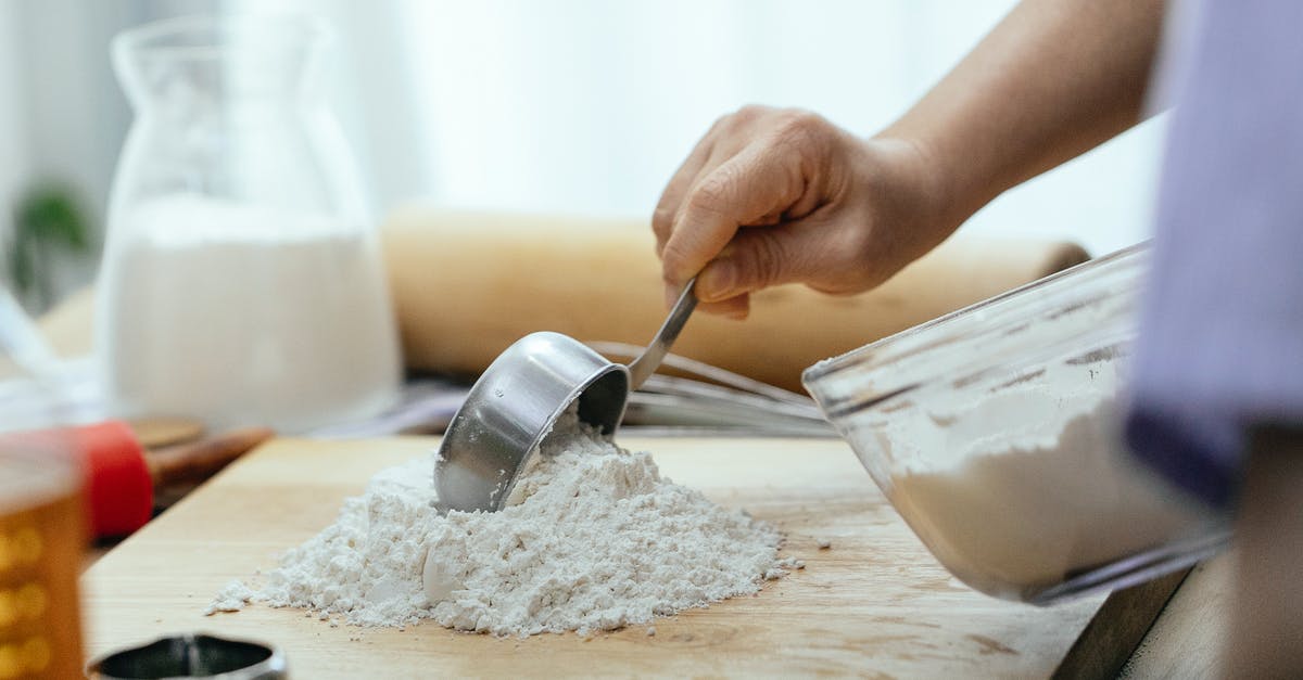 How do I make cake batter from scratch without butter? - Crop adult woman adding flour on wooden cutting board How do I make cake batter from scratch without butter? - Crop adult woman adding flour on wooden cutting board