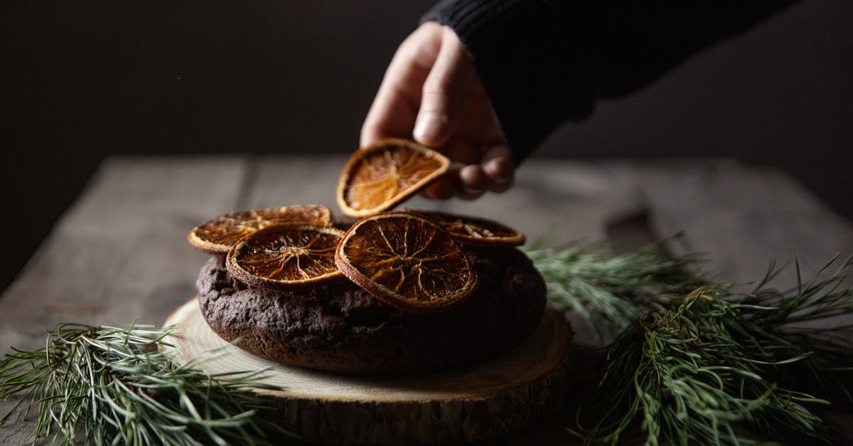 How do I make dried blueberries? - Person Holding Gold Round Coin on Brown Wooden Round Tray