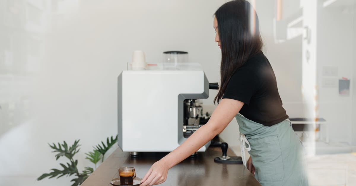 How do I prepare (any) coffee with desired caffeine concentration? - Side view of concentrated female barista in apron standing nearby professional coffee machine and serving freshly brewed aromatic espresso How do I prepare (any) coffee with desired caffeine concentration? - Side view of concentrated female barista in apron standing nearby professional coffee machine and serving freshly brewed aromatic espresso