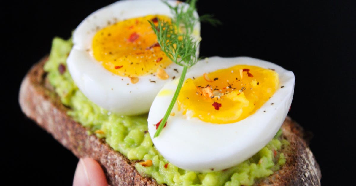 How do I prevent an egg cracking while hard boiling it? - Sliced Egg on Top of Green Salad With Bread How do I prevent an egg cracking while hard boiling it? - Sliced Egg on Top of Green Salad With Bread