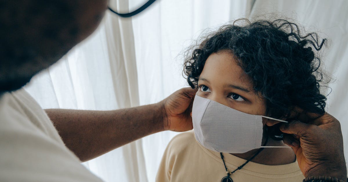 How do I prevent smoke problems indoors? - From above unrecognizable black man wearing protective mask on face of ethnic kid standing in room near window closed with curtain How do I prevent smoke problems indoors? - From above unrecognizable black man wearing protective mask on face of ethnic kid standing in room near window closed with curtain