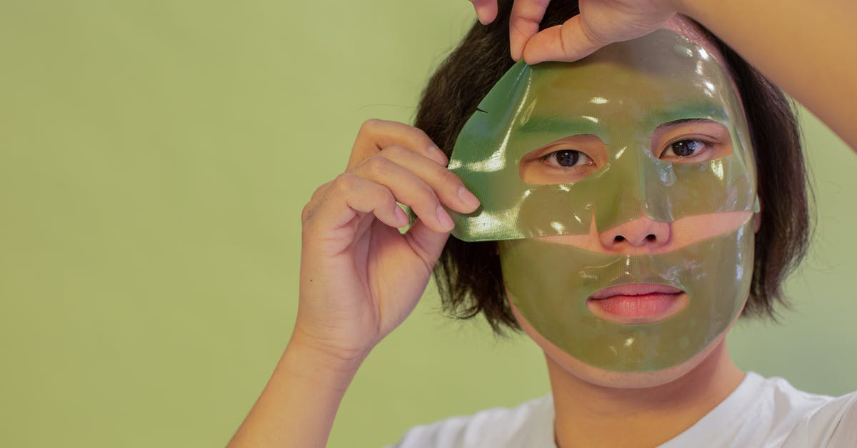 How do I remove a sheet cake from a pan? - Young unemotional Asian male in white shirt removing cleansing mask sheet from face and looking at camera against green background How do I remove a sheet cake from a pan? - Young unemotional Asian male in white shirt removing cleansing mask sheet from face and looking at camera against green background
