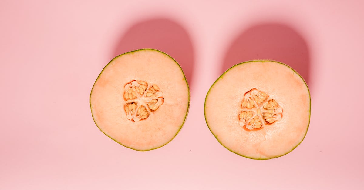 How do I remove bitterness from bitter melon - Top view of ripe orange melon cut into halves for healthy diet placed on pink background in modern light studio How do I remove bitterness from bitter melon - Top view of ripe orange melon cut into halves for healthy diet placed on pink background in modern light studio