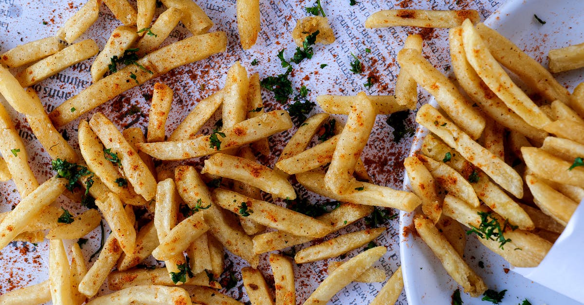 How do I safely deep fry a turkey? - Heap of delicious crunchy fried potatoes spilled on table How do I safely deep fry a turkey? - Heap of delicious crunchy fried potatoes spilled on table