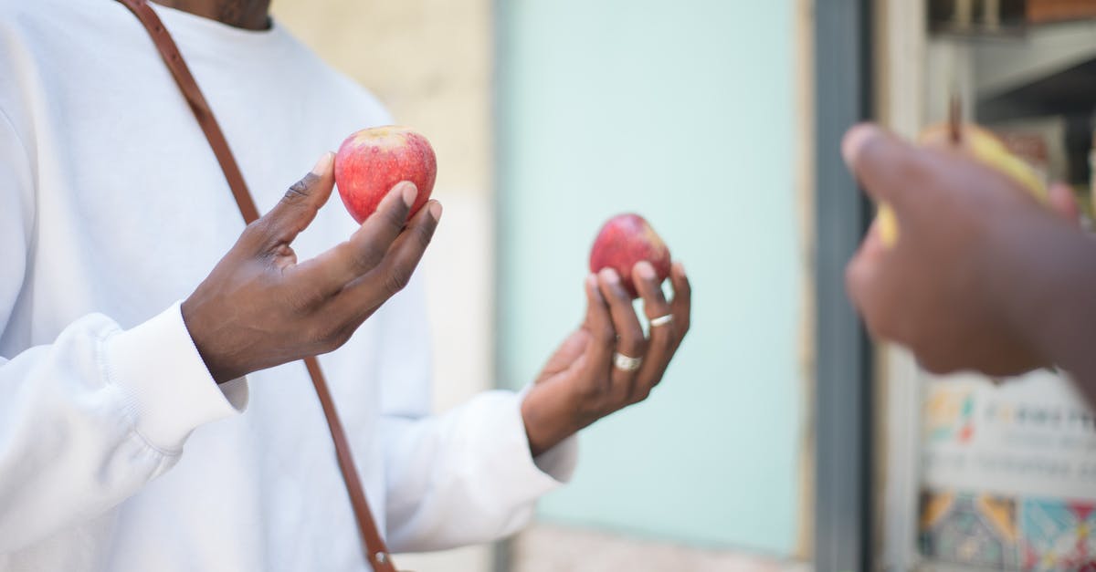 How do I store apples in an apartment? - Person in White Long Sleeve Shirt Holding Apples How do I store apples in an apartment? - Person in White Long Sleeve Shirt Holding Apples