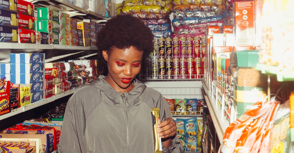 How do I store untempered chocolate? - Positive ethnic woman choosing food in grocery store How do I store untempered chocolate? - Positive ethnic woman choosing food in grocery store