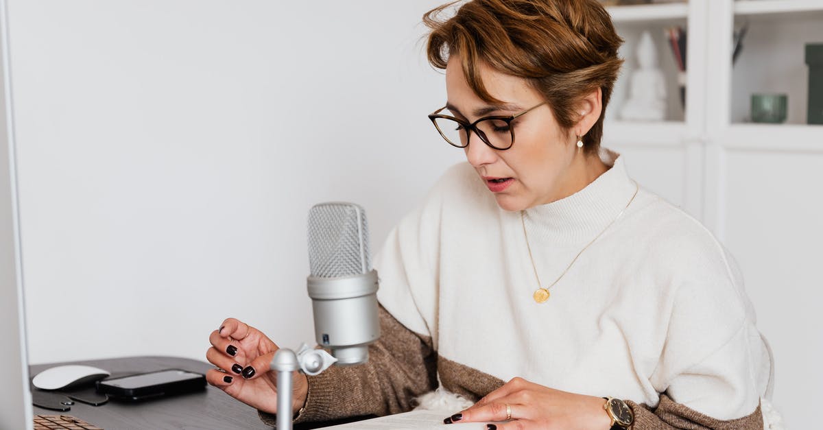 How do I tell if my cheese culture is still good? - Female narrator in glasses reading out loud from book while sitting at desk with microphone and recording audiobook in cozy study How do I tell if my cheese culture is still good? - Female narrator in glasses reading out loud from book while sitting at desk with microphone and recording audiobook in cozy study