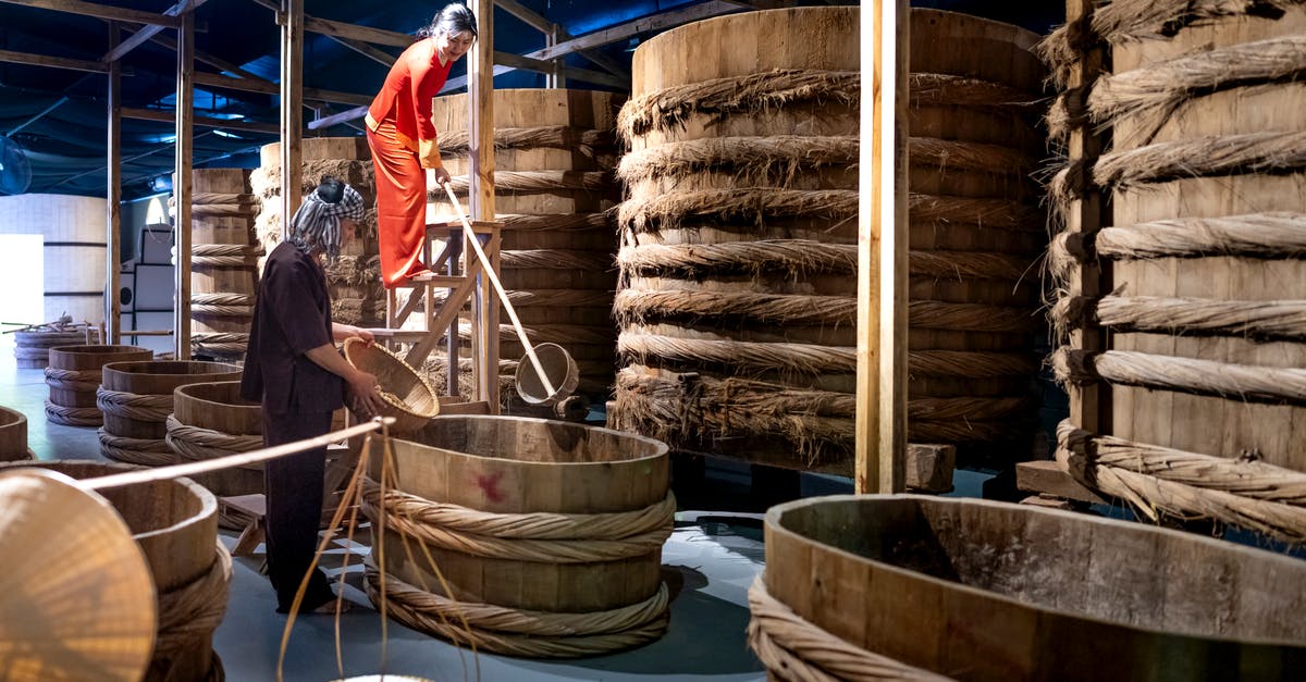 How do I tell if my fermented sauce has gone bad? - Factory employees with wooden buckets near barrels with ropes in fish sauce factory How do I tell if my fermented sauce has gone bad? - Factory employees with wooden buckets near barrels with ropes in fish sauce factory