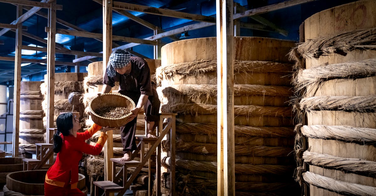 How do I tell if my fermented sauce has gone bad? - Workers near barrels in fish sauce factory How do I tell if my fermented sauce has gone bad? - Workers near barrels in fish sauce factory