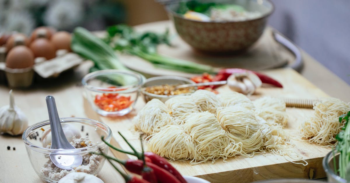 How do I tone down the flavor of garlic in spaghetti sauce - Composition of uncooked noodles on wooden board near fresh various vegetables and eggs arranged on table in kitchen before cooking Asian noodles soup How do I tone down the flavor of garlic in spaghetti sauce - Composition of uncooked noodles on wooden board near fresh various vegetables and eggs arranged on table in kitchen before cooking Asian noodles soup