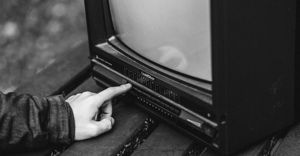 How do I use my lever press correctly? - Black and white of unrecognizable male pressing buttons on old fashioned television placed on wooden table in nature on blurred background
