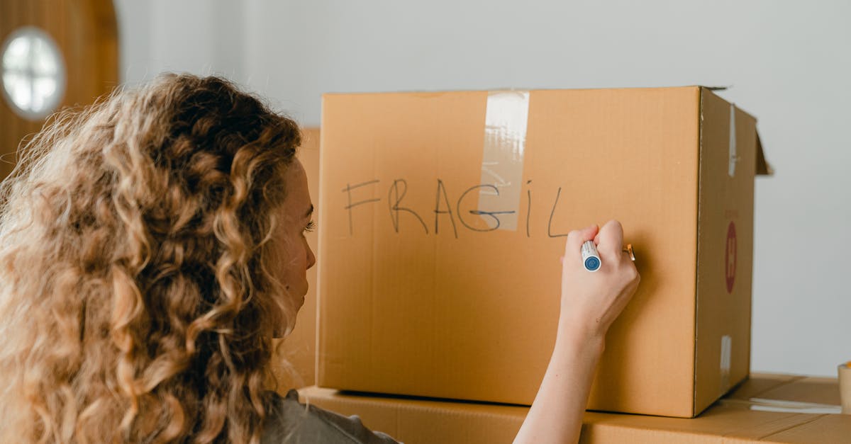 How do I wash the "pokey" side of a box grater? - Back view of unrecognizable curvy female in casual clothes writing fragile on empty side of carton box while waiting for courier How do I wash the "pokey" side of a box grater? - Back view of unrecognizable curvy female in casual clothes writing fragile on empty side of carton box while waiting for courier