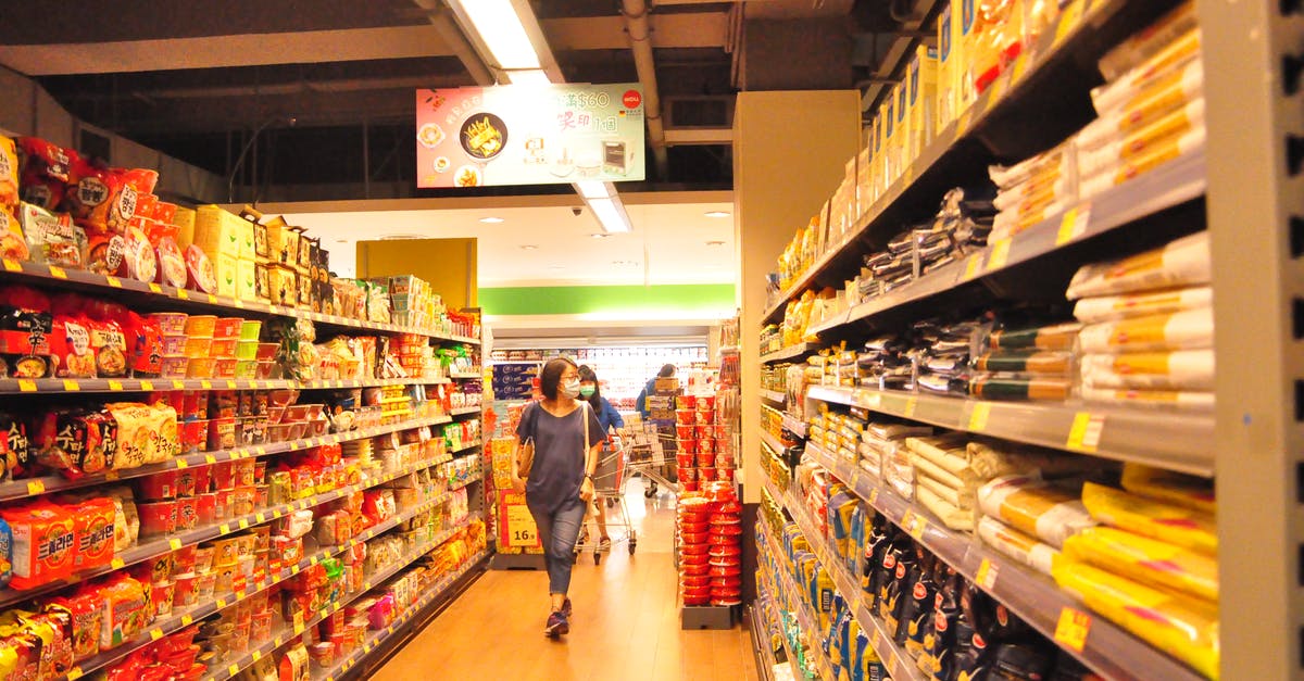 How do price and quality relate in blenders? - Female customer choosing products in market How do price and quality relate in blenders? - Female customer choosing products in market