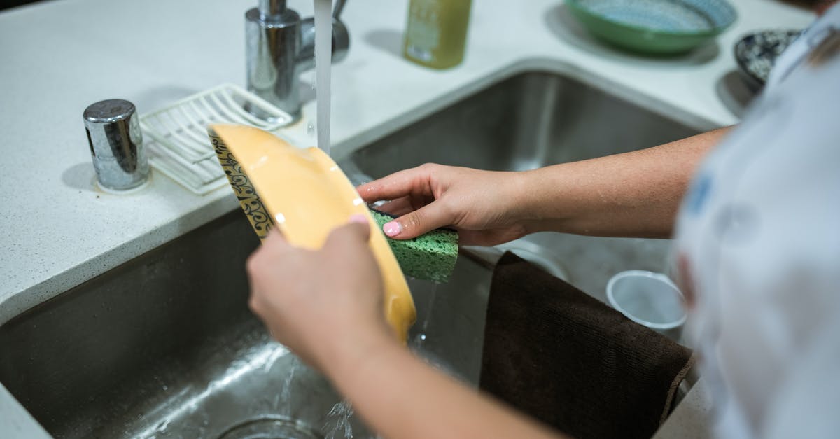 How do professional chefs keep food thermometers clean between uses? - Person Holding Yellow Plastic Container How do professional chefs keep food thermometers clean between uses? - Person Holding Yellow Plastic Container