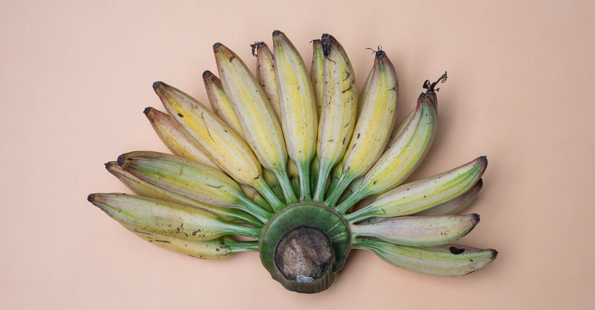 How do the nutritional values of bananas change as they ripen? - Top view composition of recently collected harvest of ripe fresh bananas placed on pink background How do the nutritional values of bananas change as they ripen? - Top view composition of recently collected harvest of ripe fresh bananas placed on pink background