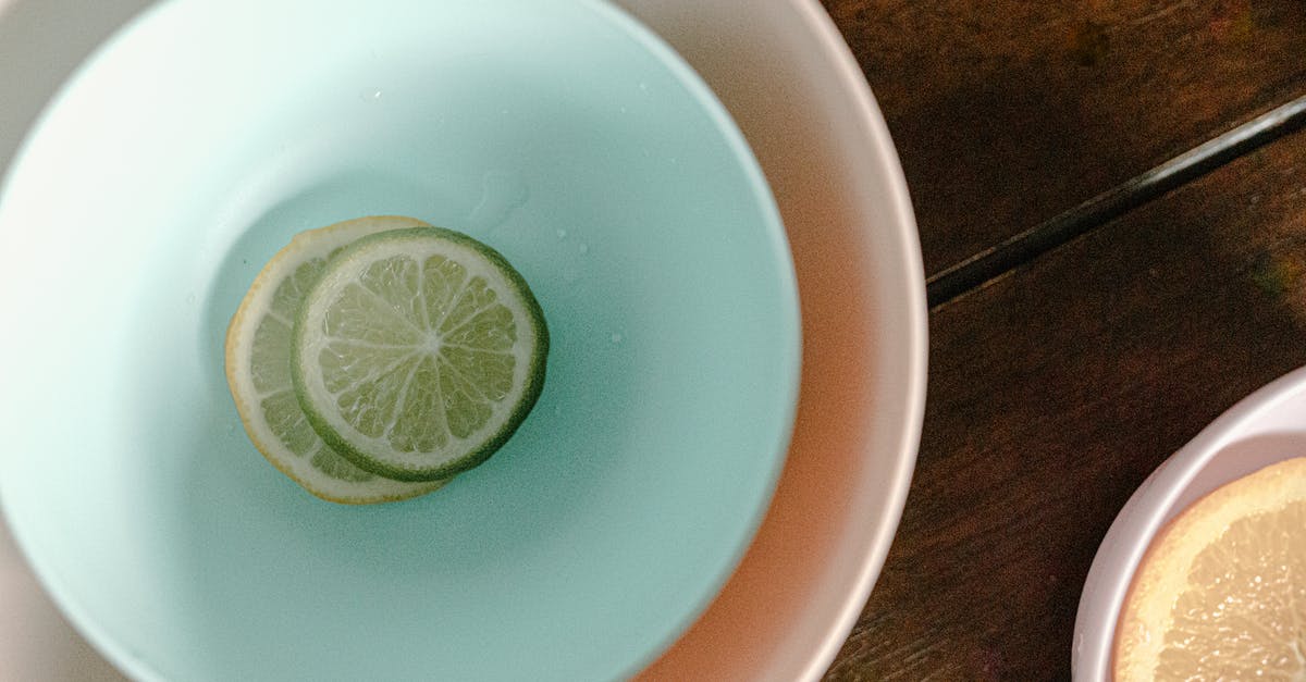 How do tomatillos differ in taste from under-ripe tomatoes? - Bowls with sliced lemon and lime How do tomatillos differ in taste from under-ripe tomatoes? - Bowls with sliced lemon and lime