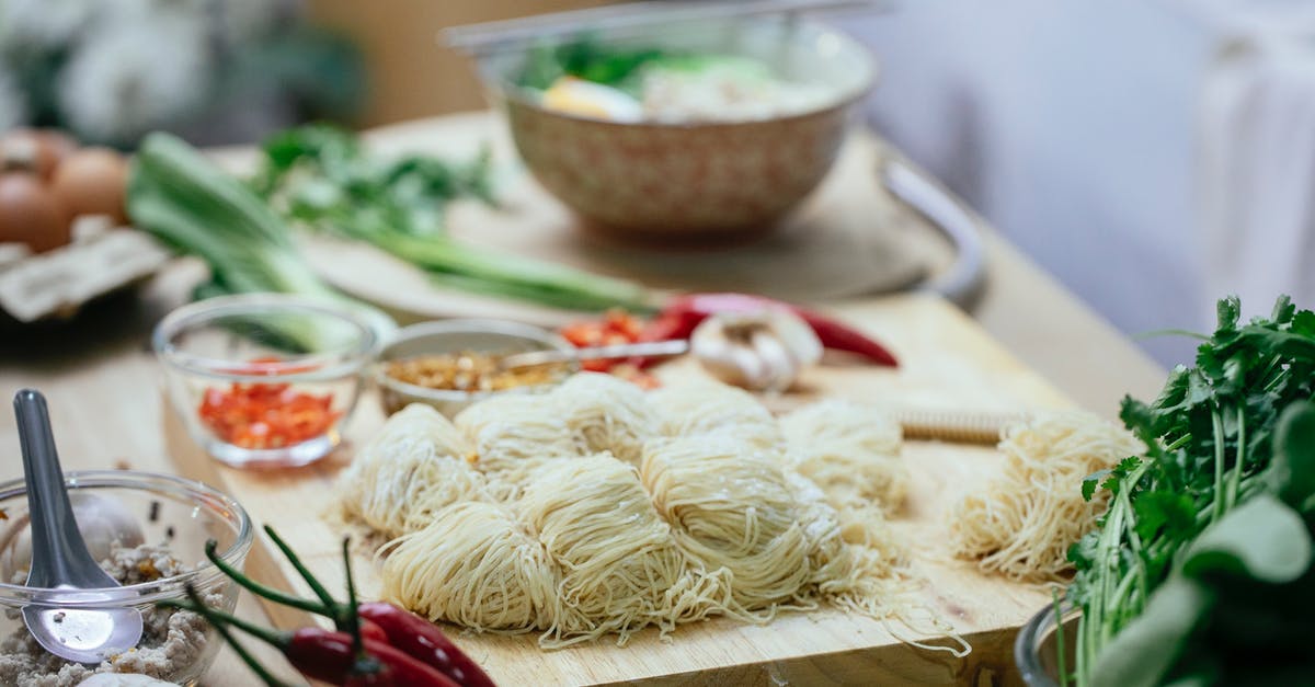 How do you cook flavored pasta? - Composition of uncooked noodles and fresh vegetables on kitchen counter How do you cook flavored pasta? - Composition of uncooked noodles and fresh vegetables on kitchen counter