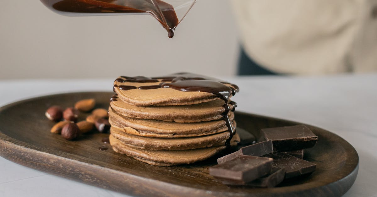 How do you cook margarine with brown sugar without separating? - Fresh appetizing pancakes poured with hot chocolate on wooden board How do you cook margarine with brown sugar without separating? - Fresh appetizing pancakes poured with hot chocolate on wooden board
