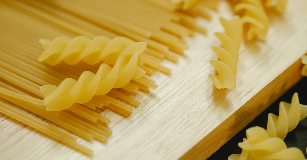 How do you eat this type of Gingko nut? - From above closeup of fusilli and spaghetti placed on wooden board for cooking dish How do you eat this type of Gingko nut? - From above closeup of fusilli and spaghetti placed on wooden board for cooking dish