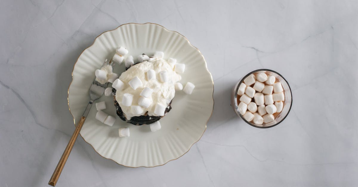How do you form Marshmallow Ropes? - Top view of plate and fork with delicate white marshmallow and chocolate topping near cocoa How do you form Marshmallow Ropes? - Top view of plate and fork with delicate white marshmallow and chocolate topping near cocoa