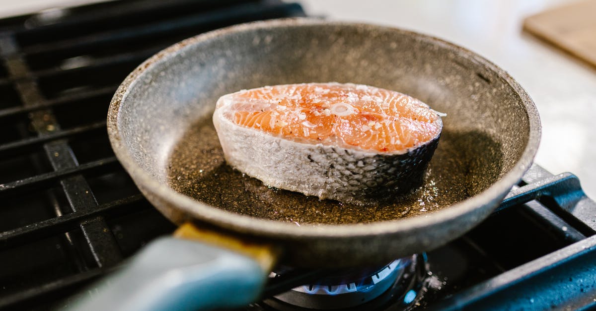 How do you fry a fat, uneven salmon filet? - Close-up of Salmon Cooking in Frying Pan How do you fry a fat, uneven salmon filet? - Close-up of Salmon Cooking in Frying Pan