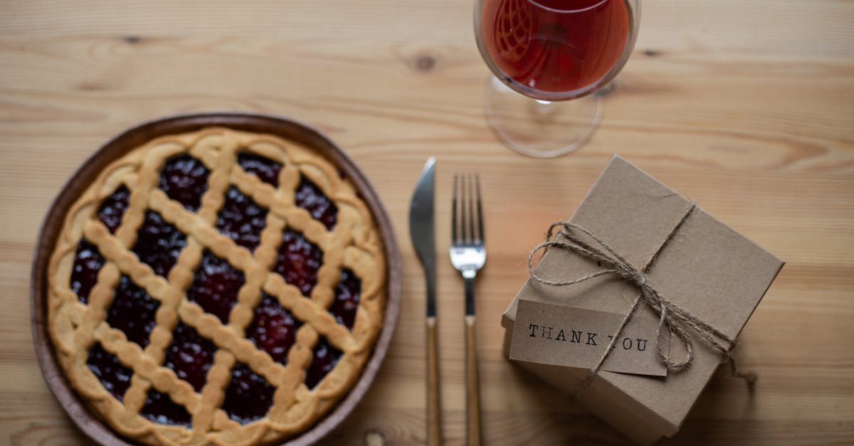 How do you get this pie top? - Delicious pie near glass of wine and gift box on table How do you get this pie top? - Delicious pie near glass of wine and gift box on table