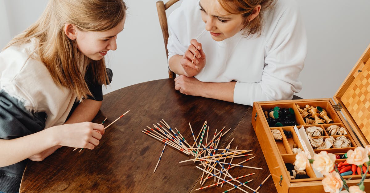 How do you keep ebelskivers from sticking? - Girl in White Long Sleeve Shirt Holding Brown Wooden Brush