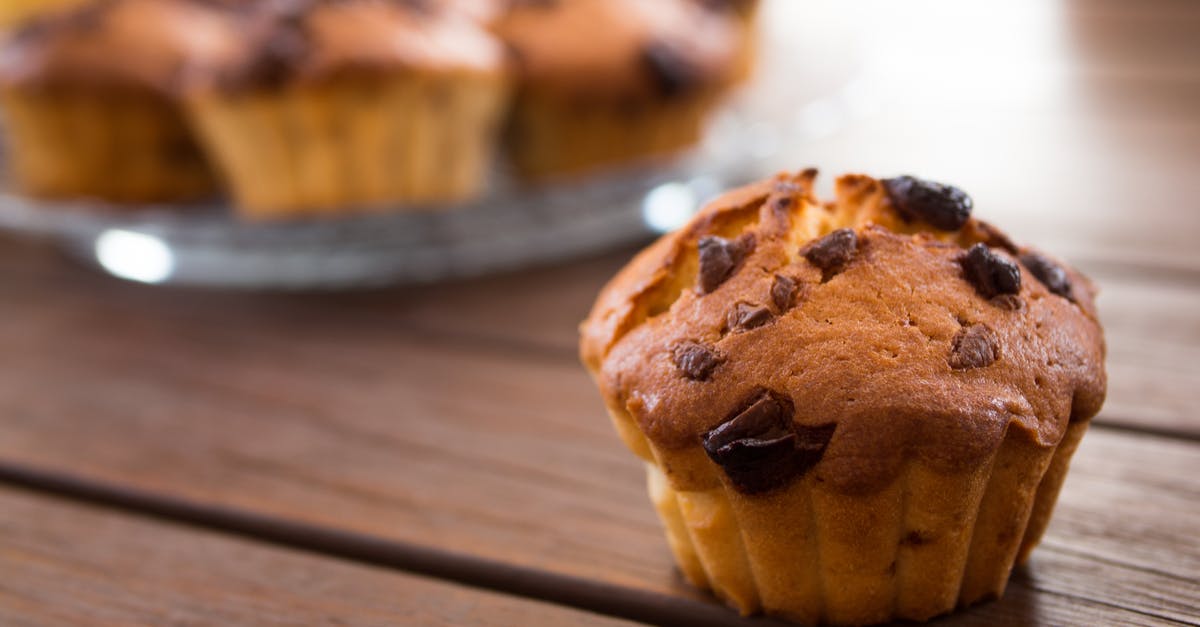 How do you make a chocolate chip cookie where the chips remain gooey after baked and cooled? - Brown Cupcake on Brown Wooden Table How do you make a chocolate chip cookie where the chips remain gooey after baked and cooled? - Brown Cupcake on Brown Wooden Table