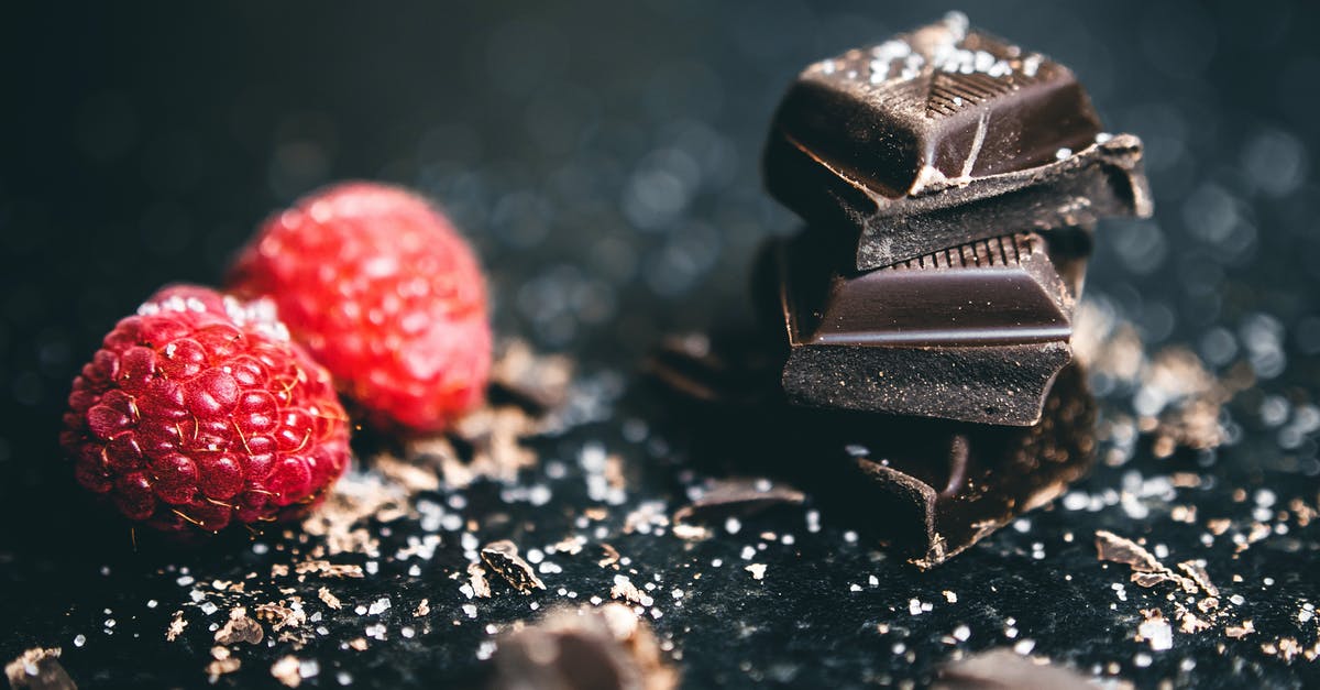 How do you make Welch's fruit snacks? - Close-Up Photo Of Stacked Chocolates Bars Beside Raspberries
