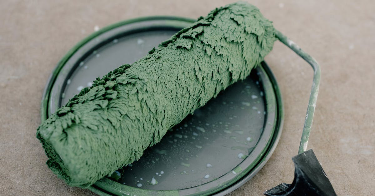 How do you prepare squid tentacles? - High angle of wet dirty roller for painting on plastic cap from paint on floor How do you prepare squid tentacles? - High angle of wet dirty roller for painting on plastic cap from paint on floor