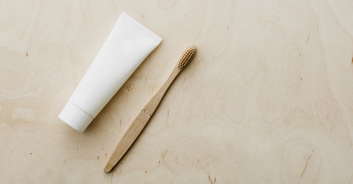 How do you reduce a cream sauce? - White tube and bamboo brush on wooden table How do you reduce a cream sauce? - White tube and bamboo brush on wooden table