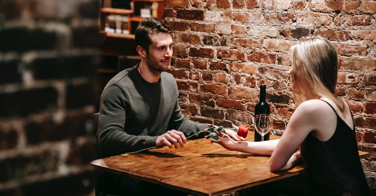 How do you reduce wine when deglazing without burning the fond? - Loving boyfriend giving red rose to girlfriend while sitting near brick wall at wooden table during celebration of event in restaurant How do you reduce wine when deglazing without burning the fond? - Loving boyfriend giving red rose to girlfriend while sitting near brick wall at wooden table during celebration of event in restaurant