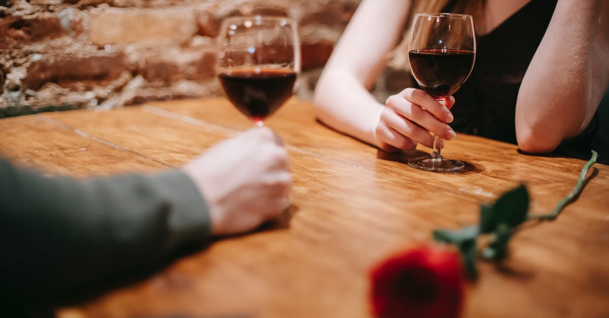 How do you reduce wine when deglazing without burning the fond? - Crop anonymous couple in elegant outfits enjoying romantic date in bar at table with red rose and glasses with wine near brick wall How do you reduce wine when deglazing without burning the fond? - Crop anonymous couple in elegant outfits enjoying romantic date in bar at table with red rose and glasses with wine near brick wall