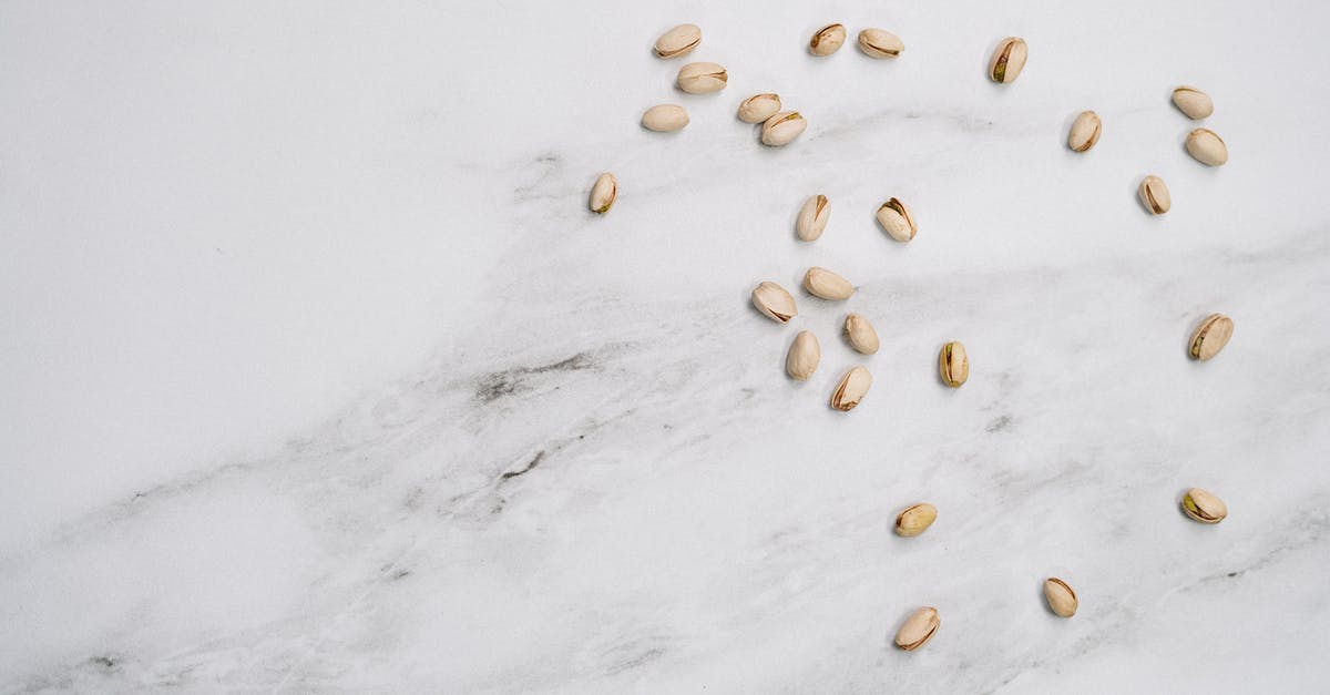 How do you shell groundnuts (peanuts) without breaking their kernels? - Pistachio On White Surface How do you shell groundnuts (peanuts) without breaking their kernels? - Pistachio On White Surface