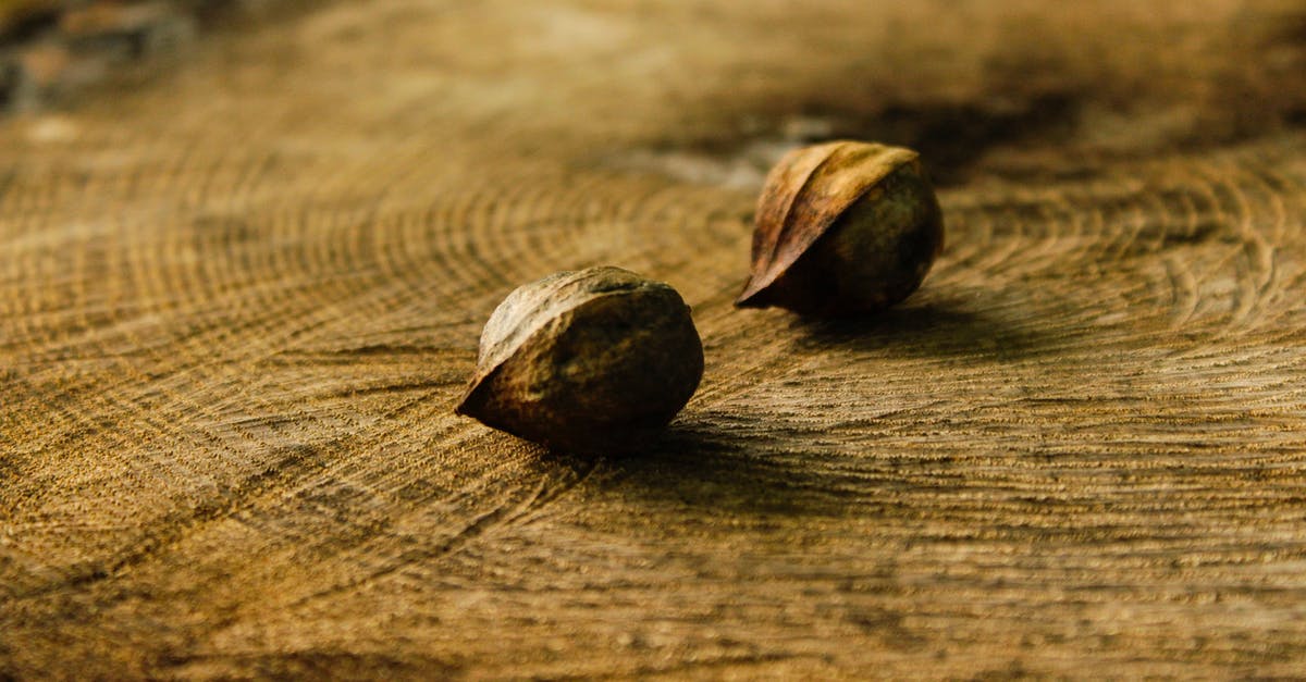How do you shell groundnuts (peanuts) without breaking their kernels? - Small brown raw nuts in shell placed together on stump in forest How do you shell groundnuts (peanuts) without breaking their kernels? - Small brown raw nuts in shell placed together on stump in forest